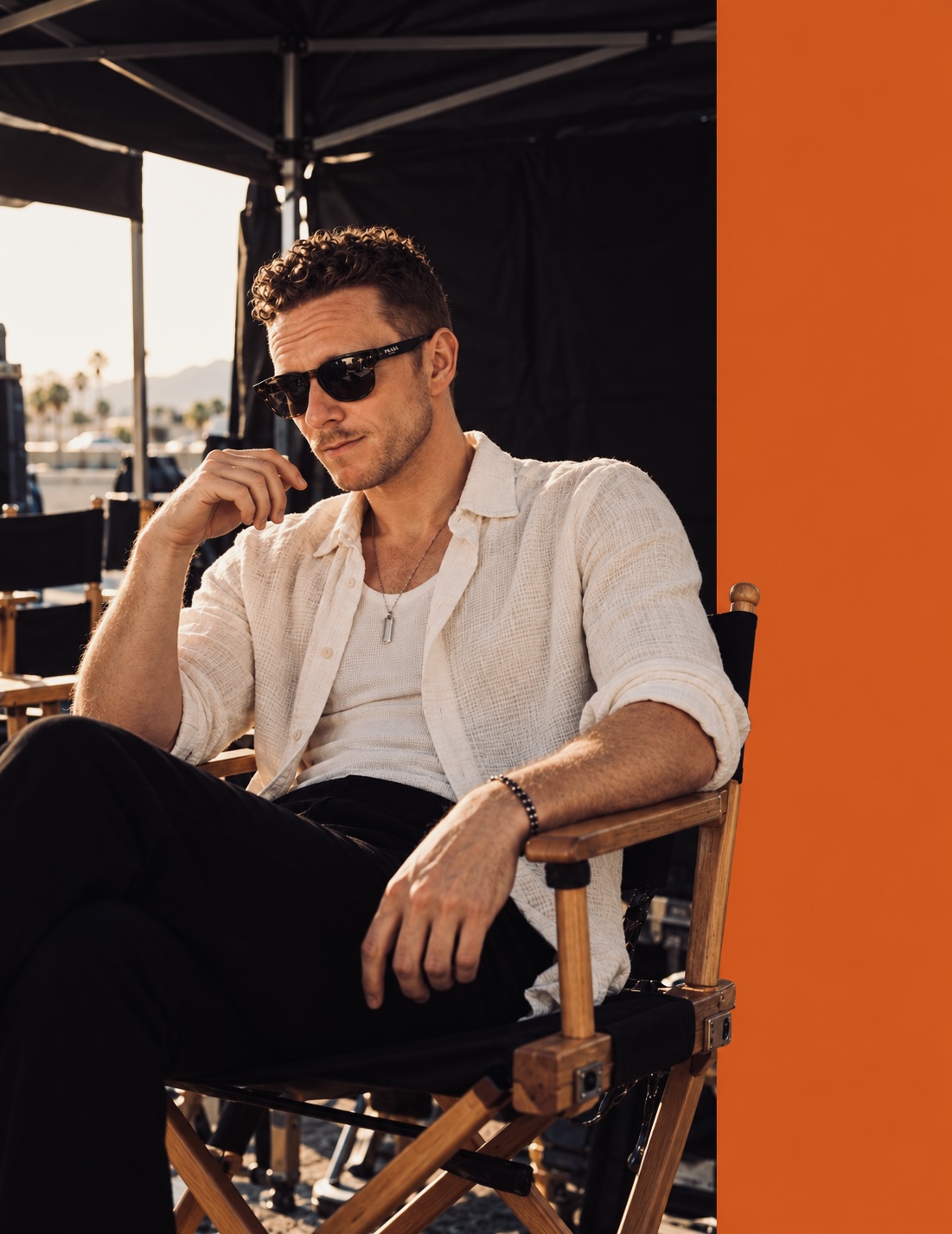 Brian Mancini seated in a director’s chair on set